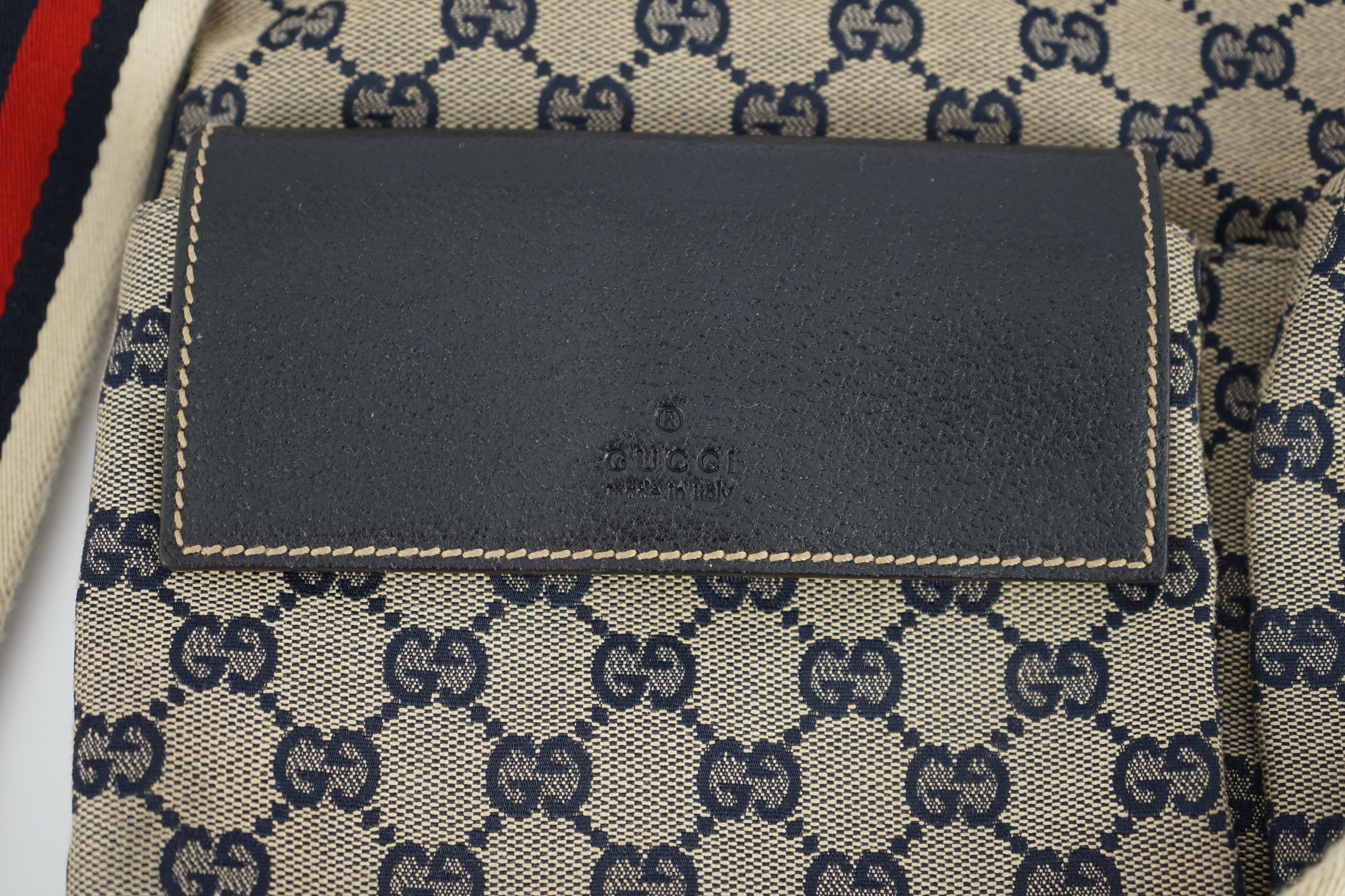A Gucci GG monogram navy double pocket messenger bag, length 35cm depth 1cm, height 29cm